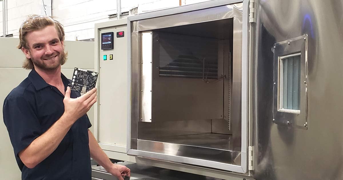 Technician holding part in front of chamber