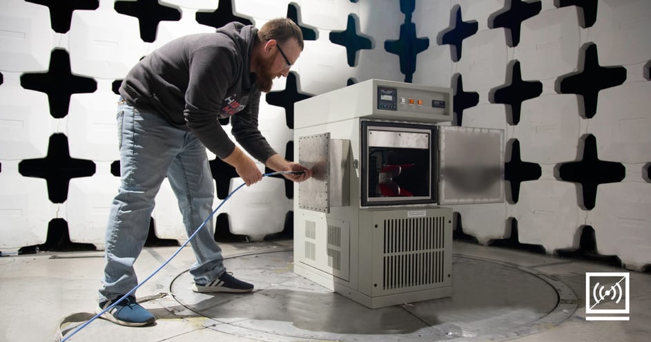 An AES employee configuring a test chamber.