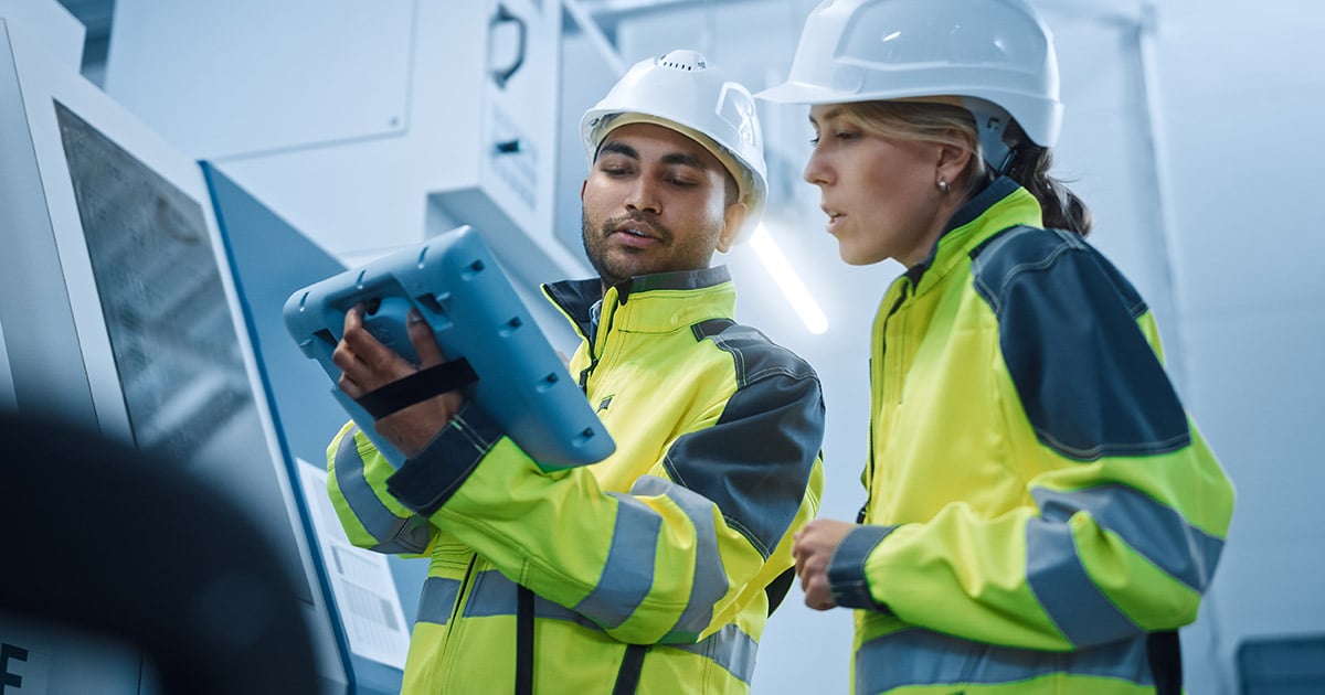 Technicians reviewing test results on a tablet computer