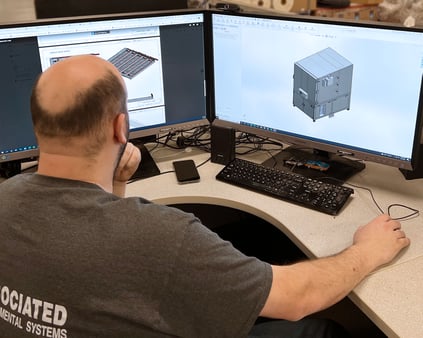 An AES employee designing a test chamber on a desktop computer.