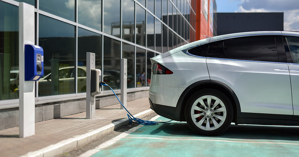 charging an electric SUV in the parking lot